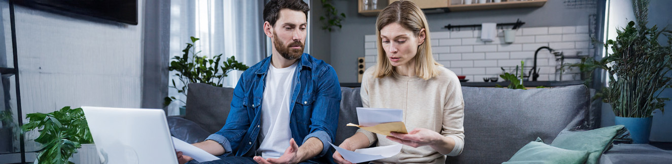 husband and wife reviewing their bills loan and mortgage agreements