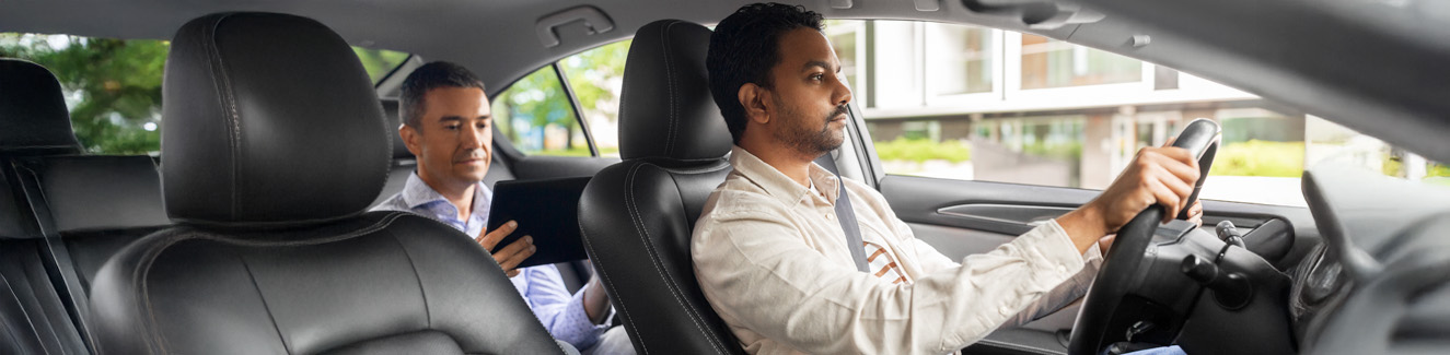 male driver driving car with passenger