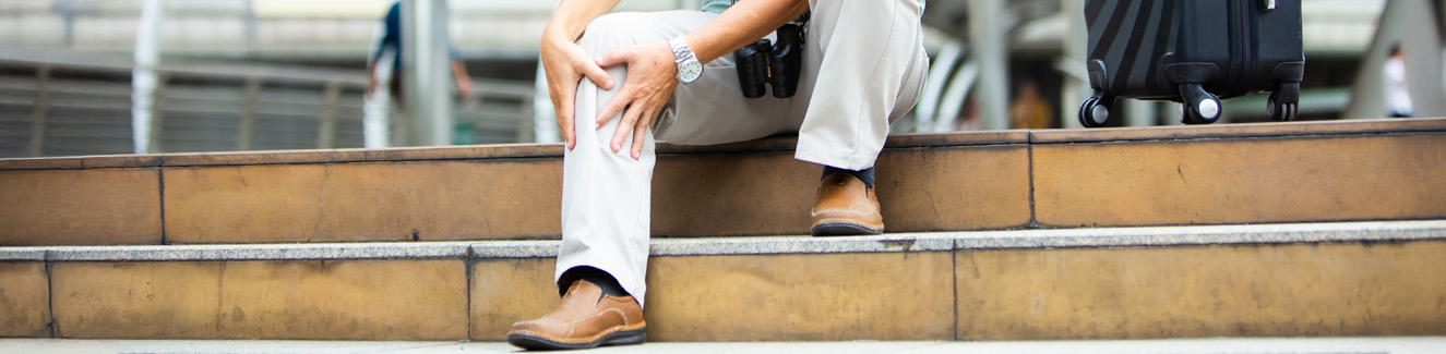 unhappy senior man suffering from knee ache